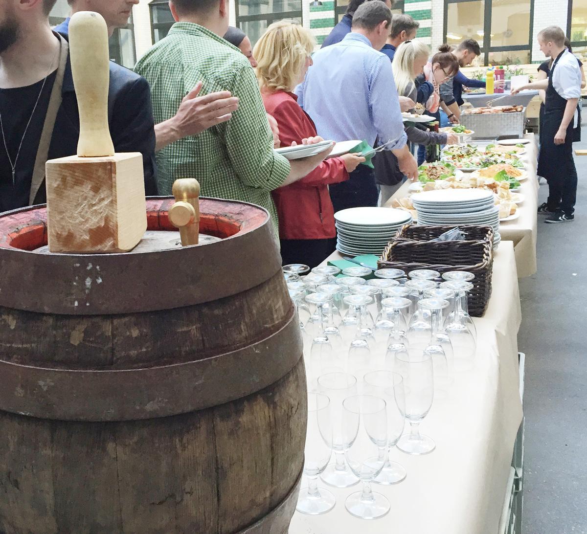 Gäste stehen vor dem Grillcatering an und befüllen ihre Teller mit mediterranen Speisen